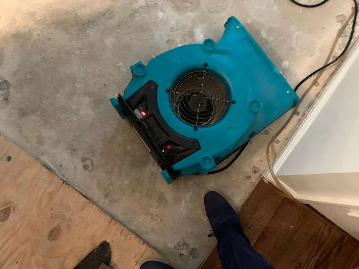 Air mover drying subfloor during Leak Detection & Repair in Rockton
